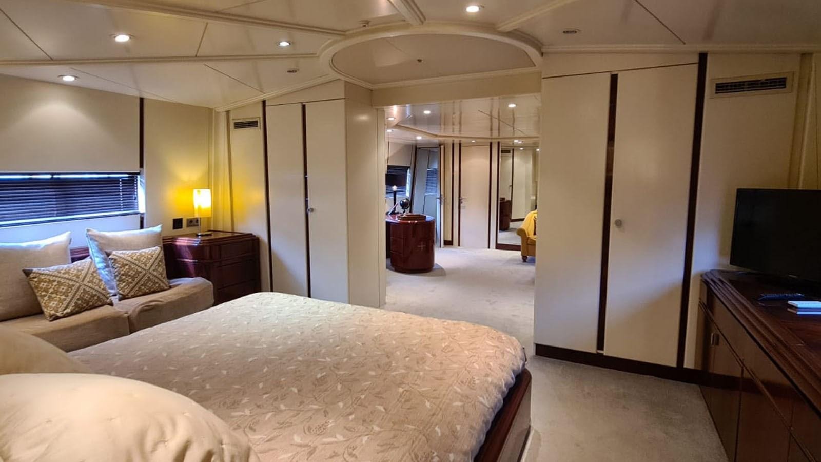 a hotel room with a bed and a tv aboard COSTA MAGNA Yacht for Sale