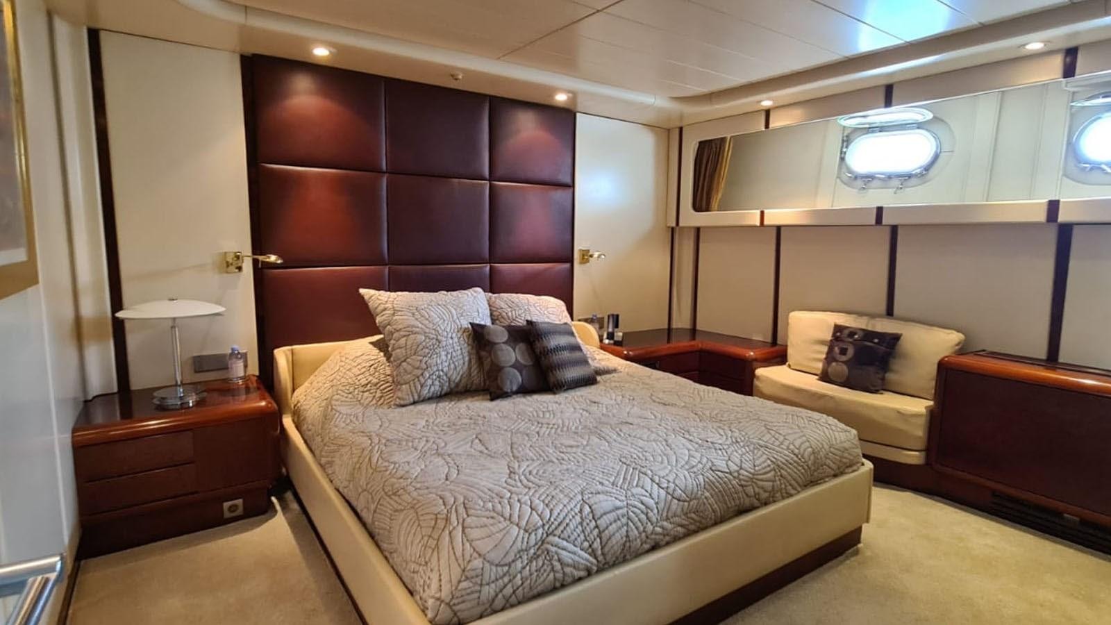 a bedroom with a bed and a desk aboard COSTA MAGNA Yacht for Sale