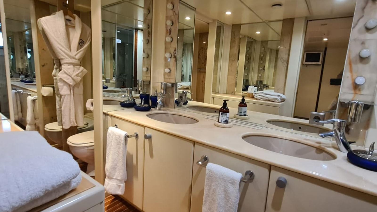 a bathroom with a large mirror aboard COSTA MAGNA Yacht for Sale