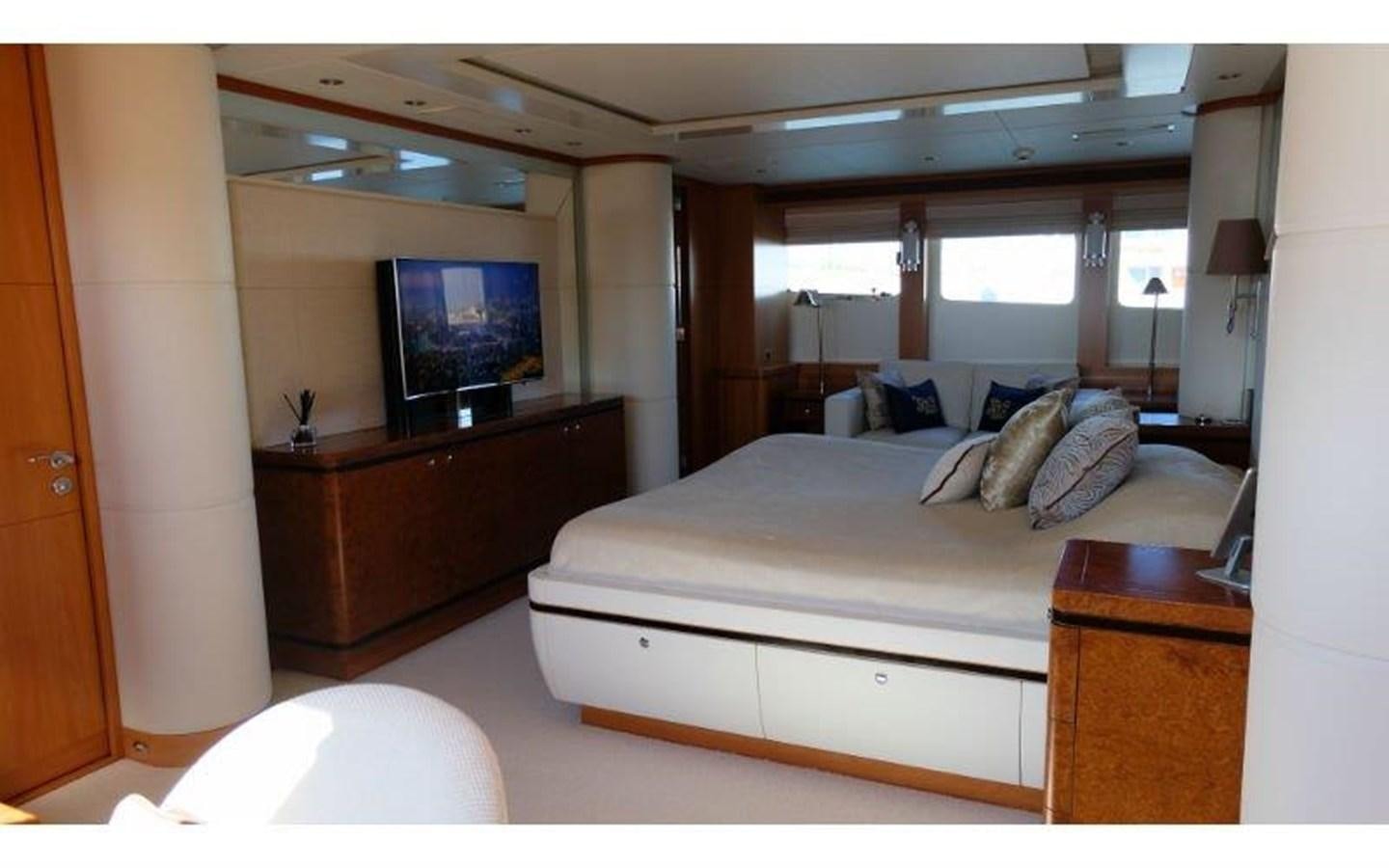 a bedroom with a bed and a tv aboard MORDAN Yacht for Sale