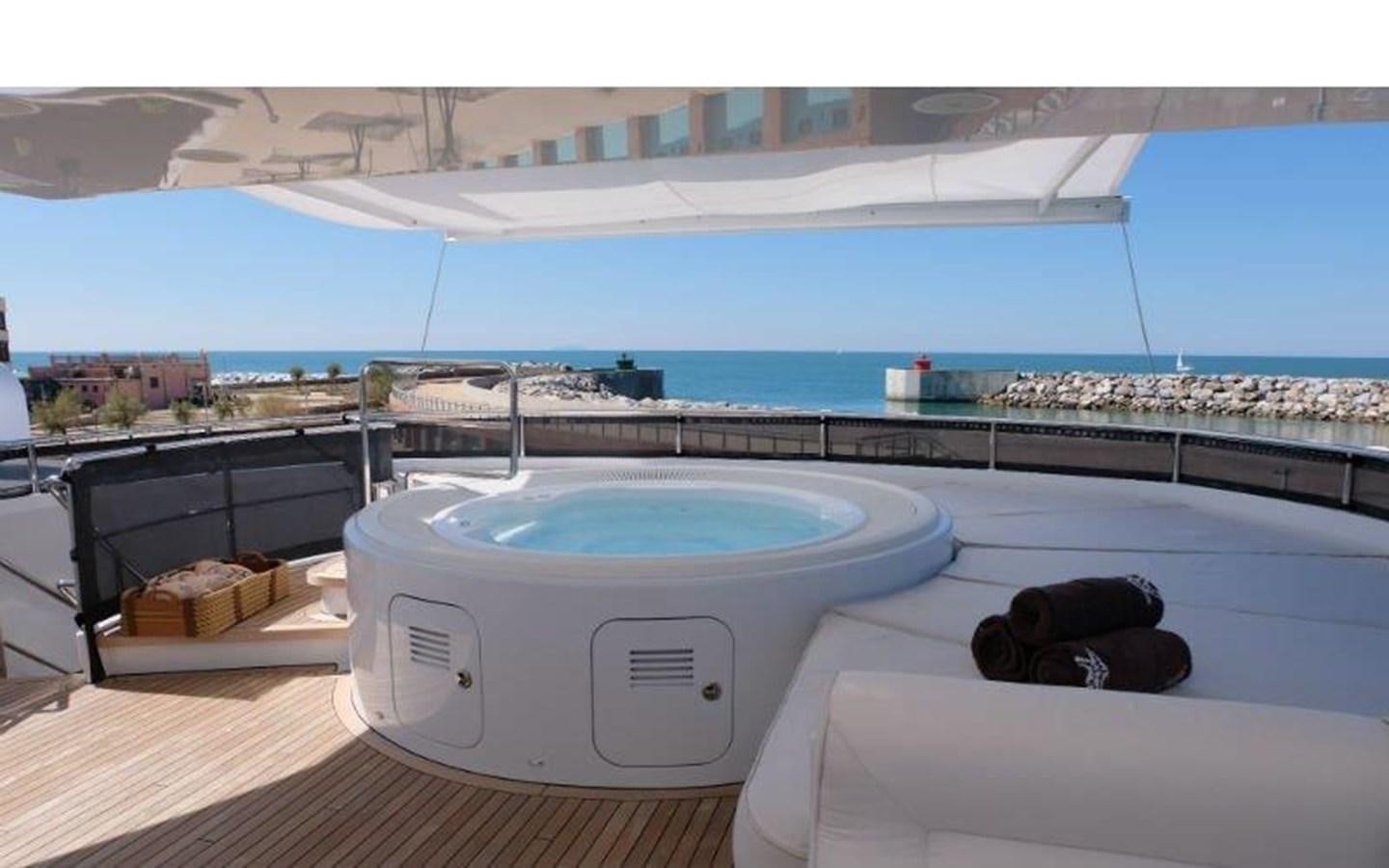 a white tub on a deck overlooking a beach aboard MORDAN Yacht for Sale