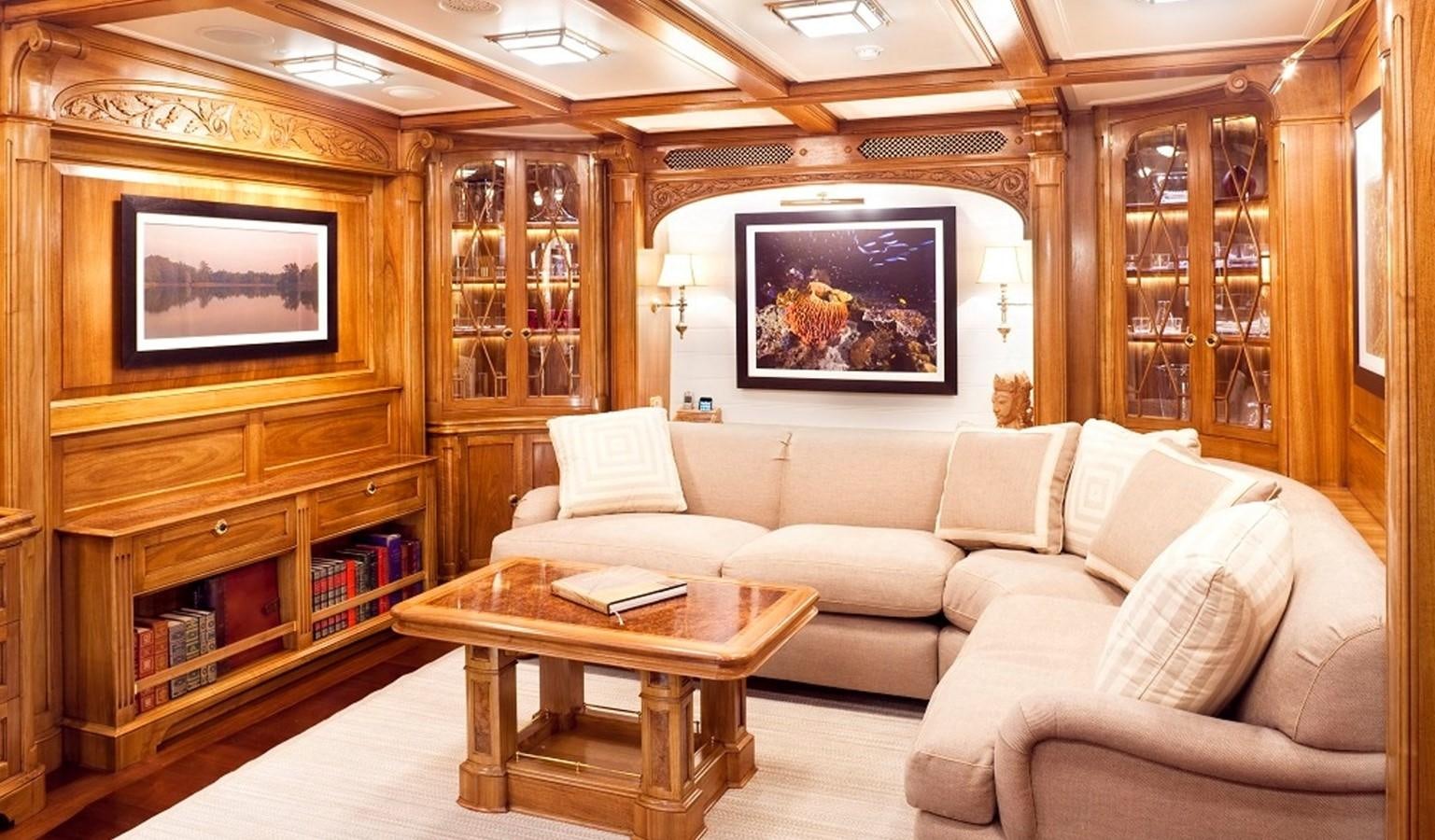 a living room with a couch and a coffee table aboard HANUMAN Yacht for Sale