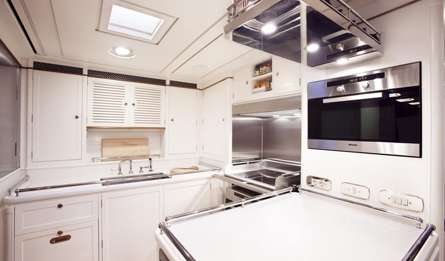 a kitchen with white cabinets aboard HANUMAN Yacht for Sale
