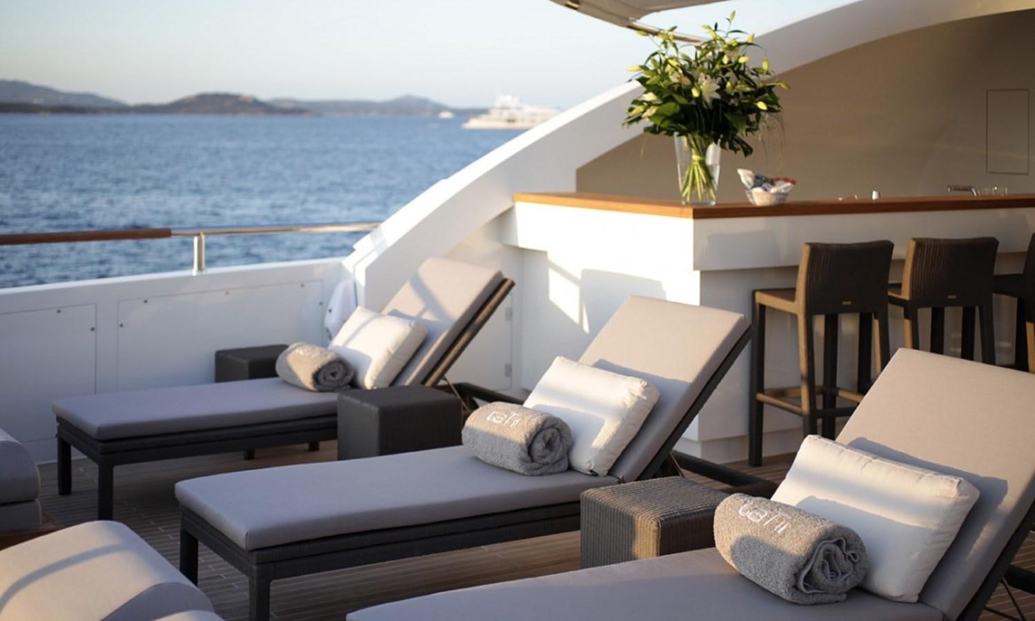 a room with a bed and a table and chairs aboard PATRIOT 41 Yacht for Sale