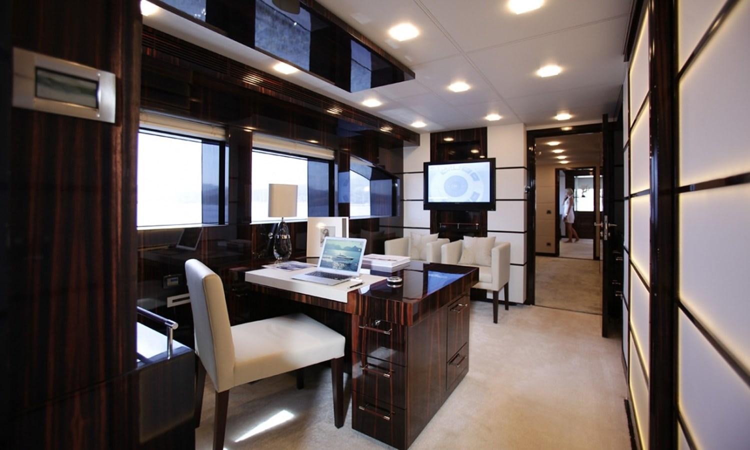 a room with a desk and chairs aboard PATRIOT 41 Yacht for Sale