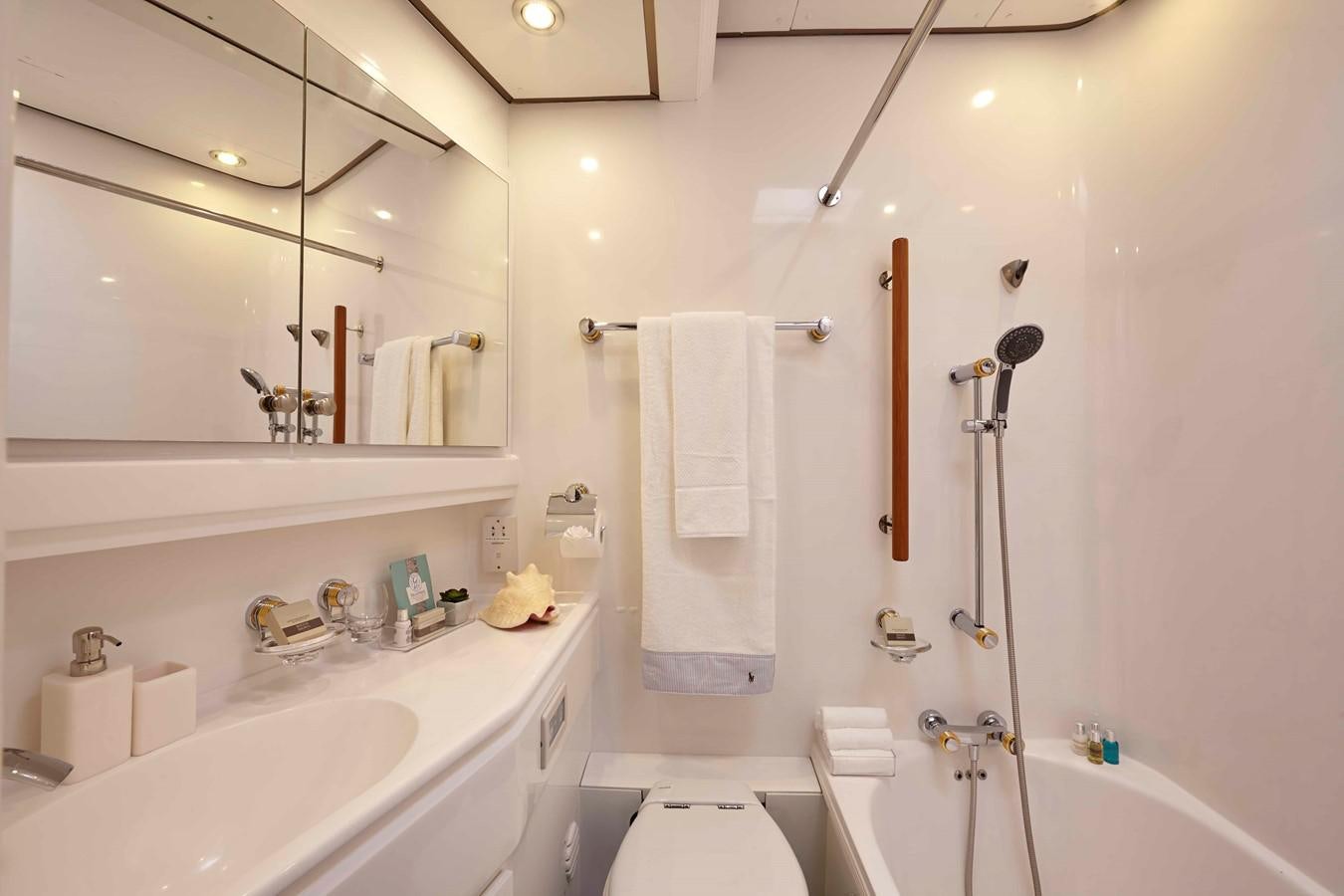 a bathroom with a shower sink and a mirror aboard MIRABELLA Yacht for Sale