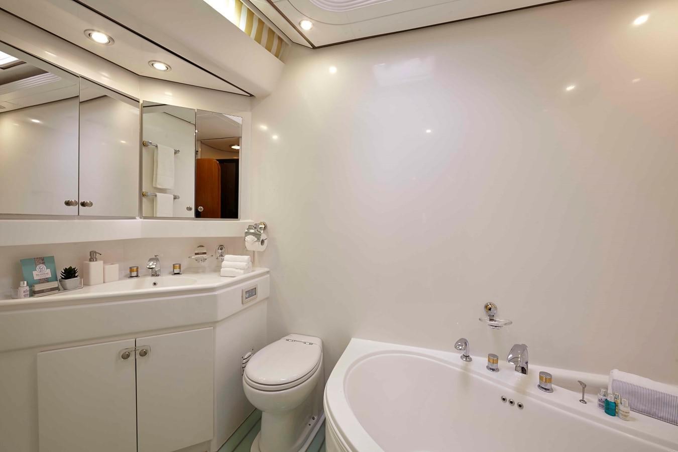a bathroom with a tub sink and toilet aboard MIRABELLA Yacht for Sale