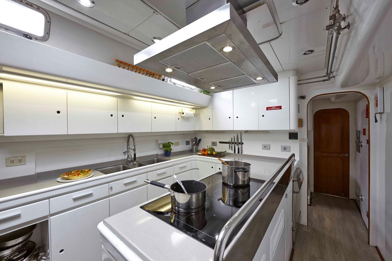 a kitchen with white cabinets aboard MIRABELLA Yacht for Sale