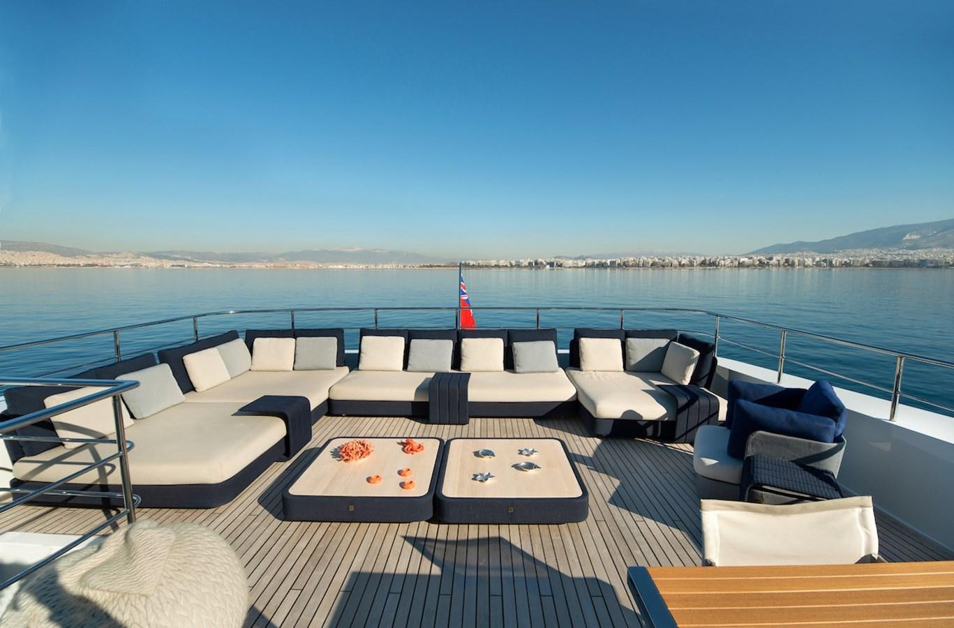 a deck with a view of the ocean and the beach aboard ASTERI Yacht for Sale