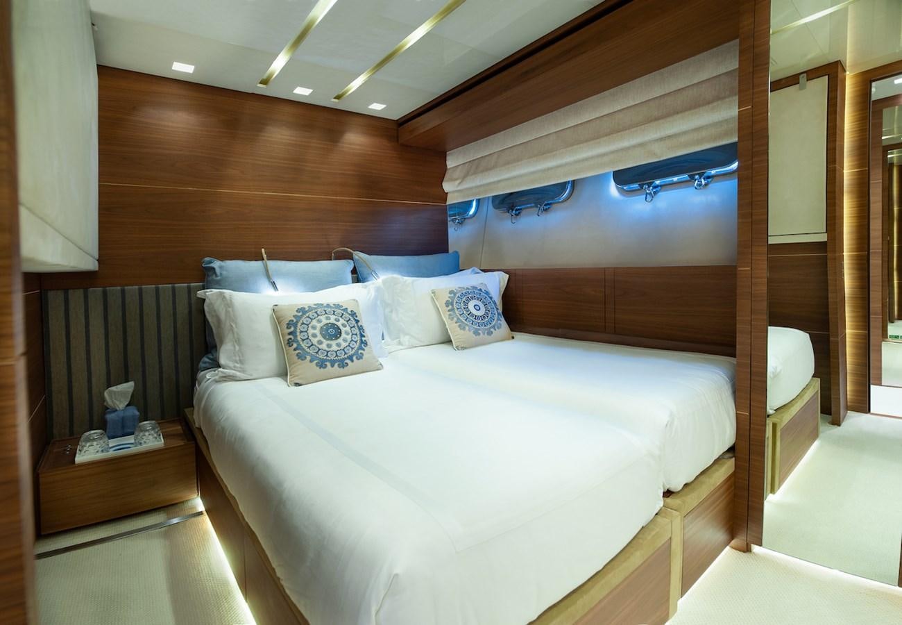 a bed with a white comforter aboard ASTERI Yacht for Sale