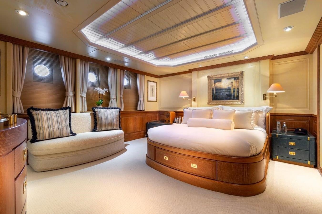 a large bedroom with a bed and a couch aboard GLACIAL BEAR Yacht for Sale