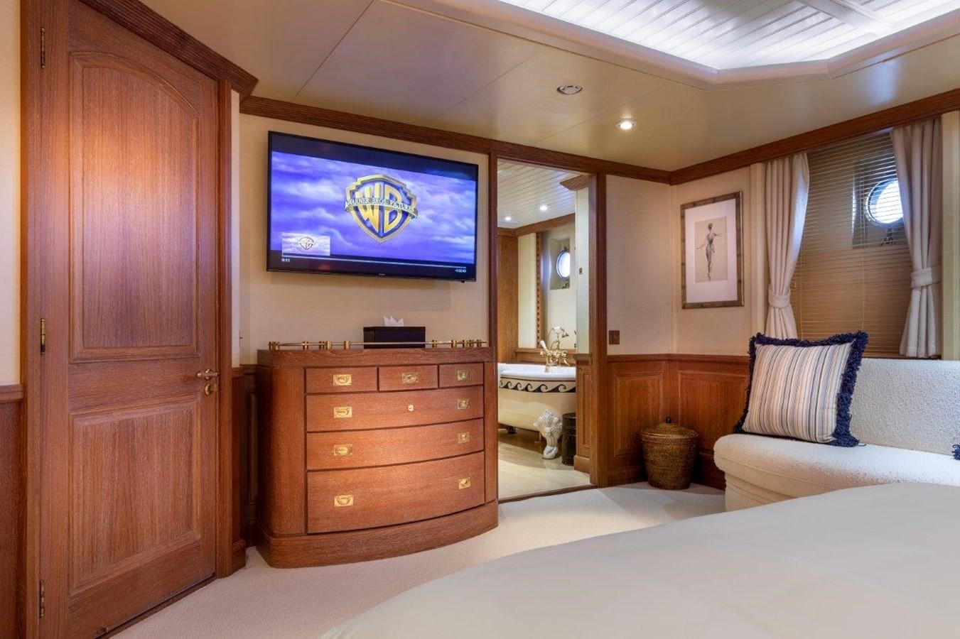 a bedroom with a tv on the wall aboard GLACIAL BEAR Yacht for Sale