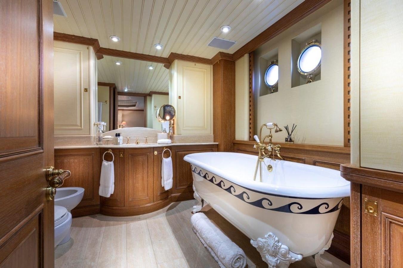 a bathroom with a tub sink and toilet aboard GLACIAL BEAR Yacht for Sale