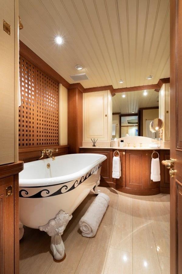a bathroom with a bathtub and sink aboard GLACIAL BEAR Yacht for Sale