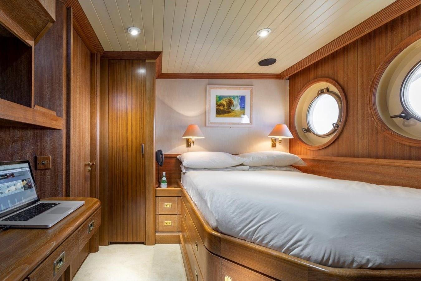 a bedroom with a laptop on the bed aboard GLACIAL BEAR Yacht for Sale