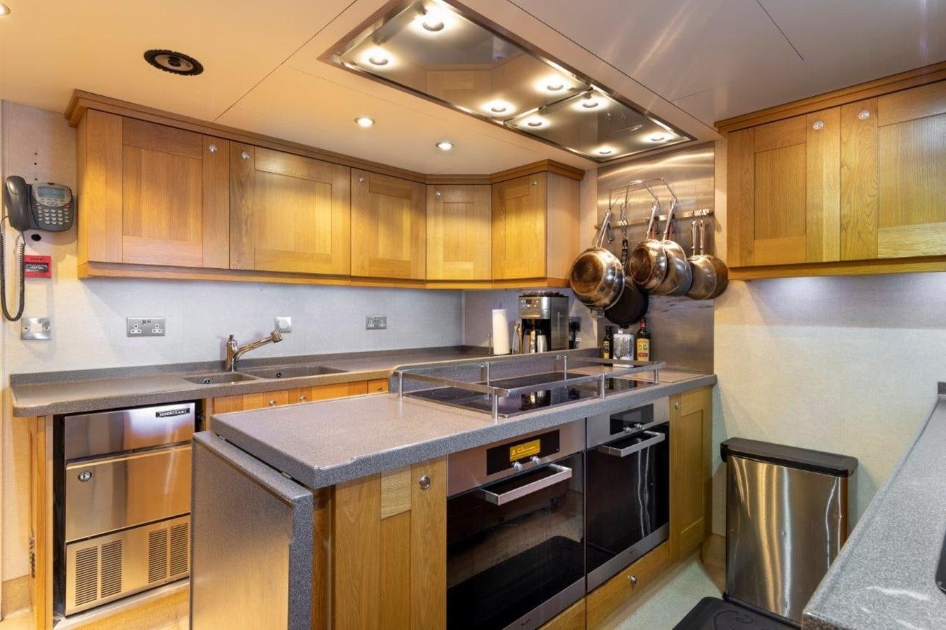 a kitchen with wooden cabinets aboard GLACIAL BEAR Yacht for Sale