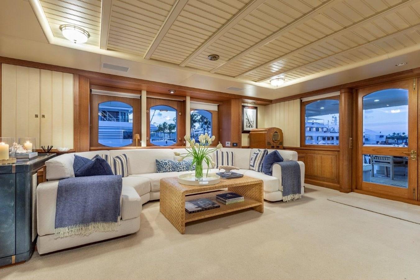 a living room with a couch and a table aboard GLACIAL BEAR Yacht for Sale
