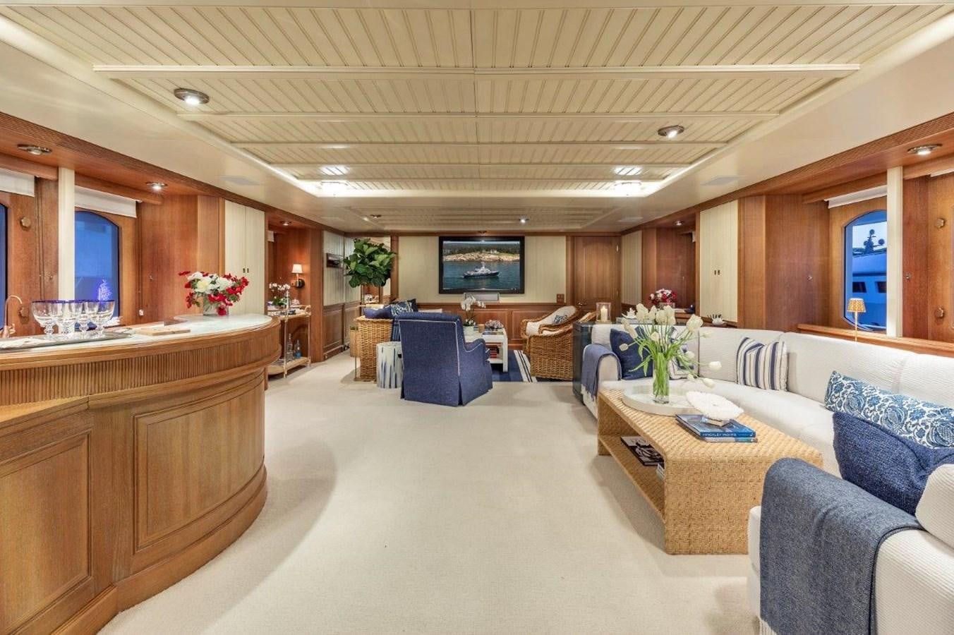 a large room with a table and chairs aboard GLACIAL BEAR Yacht for Sale