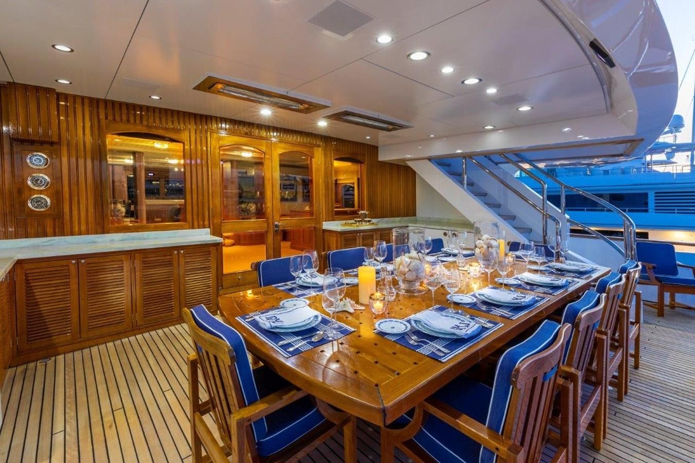a dining room with a table set for a meal aboard GLACIAL BEAR Yacht for Sale