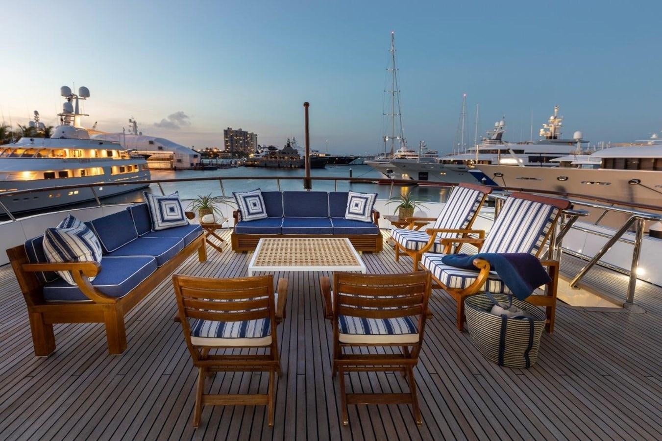 a deck with chairs and tables on it aboard GLACIAL BEAR Yacht for Sale