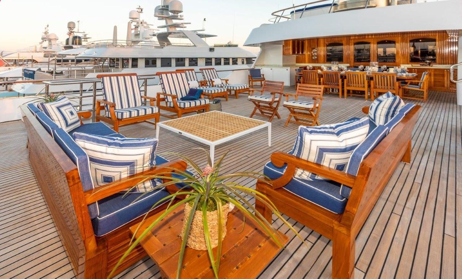 a deck with chairs and tables aboard GLACIAL BEAR Yacht for Sale