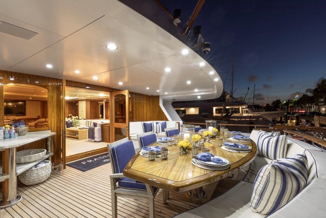 a large dining table in a living room aboard GLACIAL BEAR Yacht for Sale
