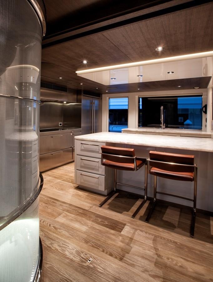 a kitchen with a table and chairs aboard PEPPER XIII Yacht for Sale