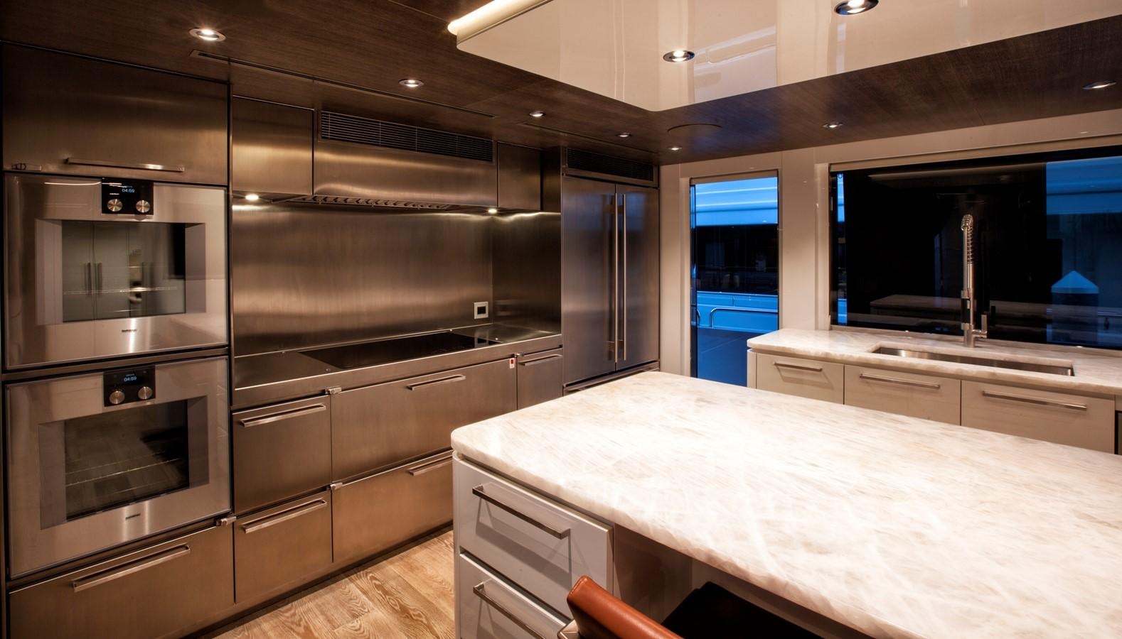 a kitchen with a large island aboard PEPPER XIII Yacht for Sale