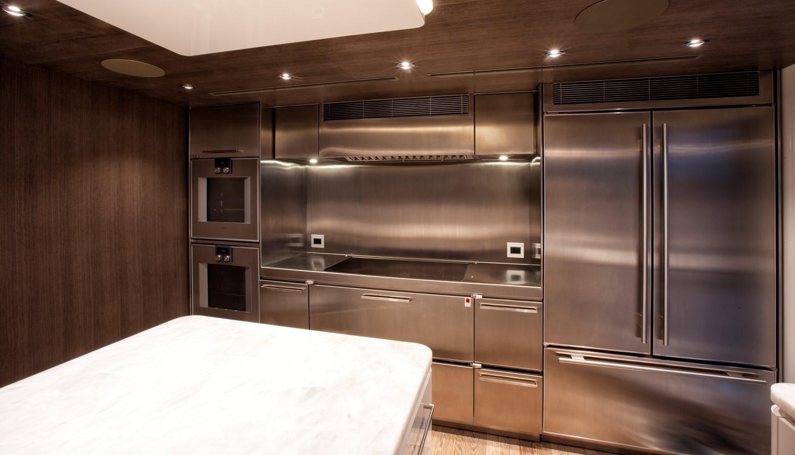 a kitchen with stainless steel appliances aboard PEPPER XIII Yacht for Sale