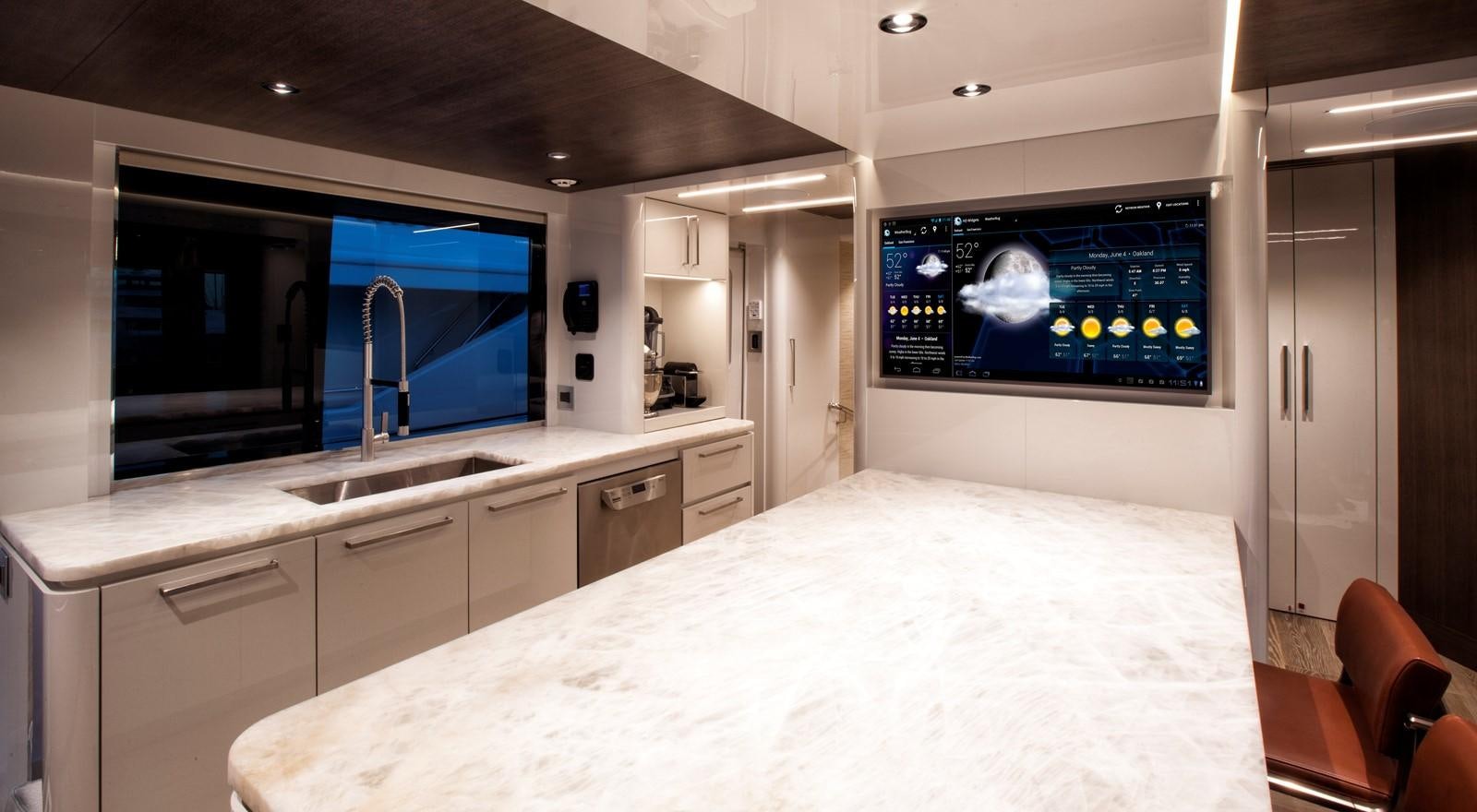 a large kitchen with a large tv aboard PEPPER XIII Yacht for Sale