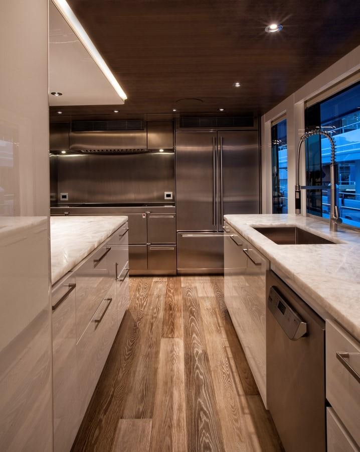 a kitchen with a large island aboard PEPPER XIII Yacht for Sale