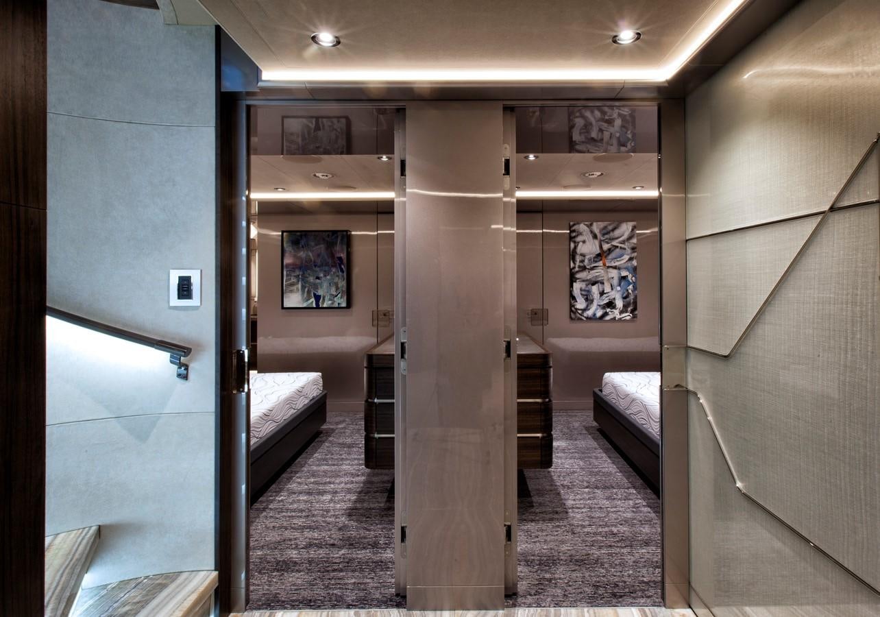 a hallway with a bed and a door aboard PEPPER XIII Yacht for Sale