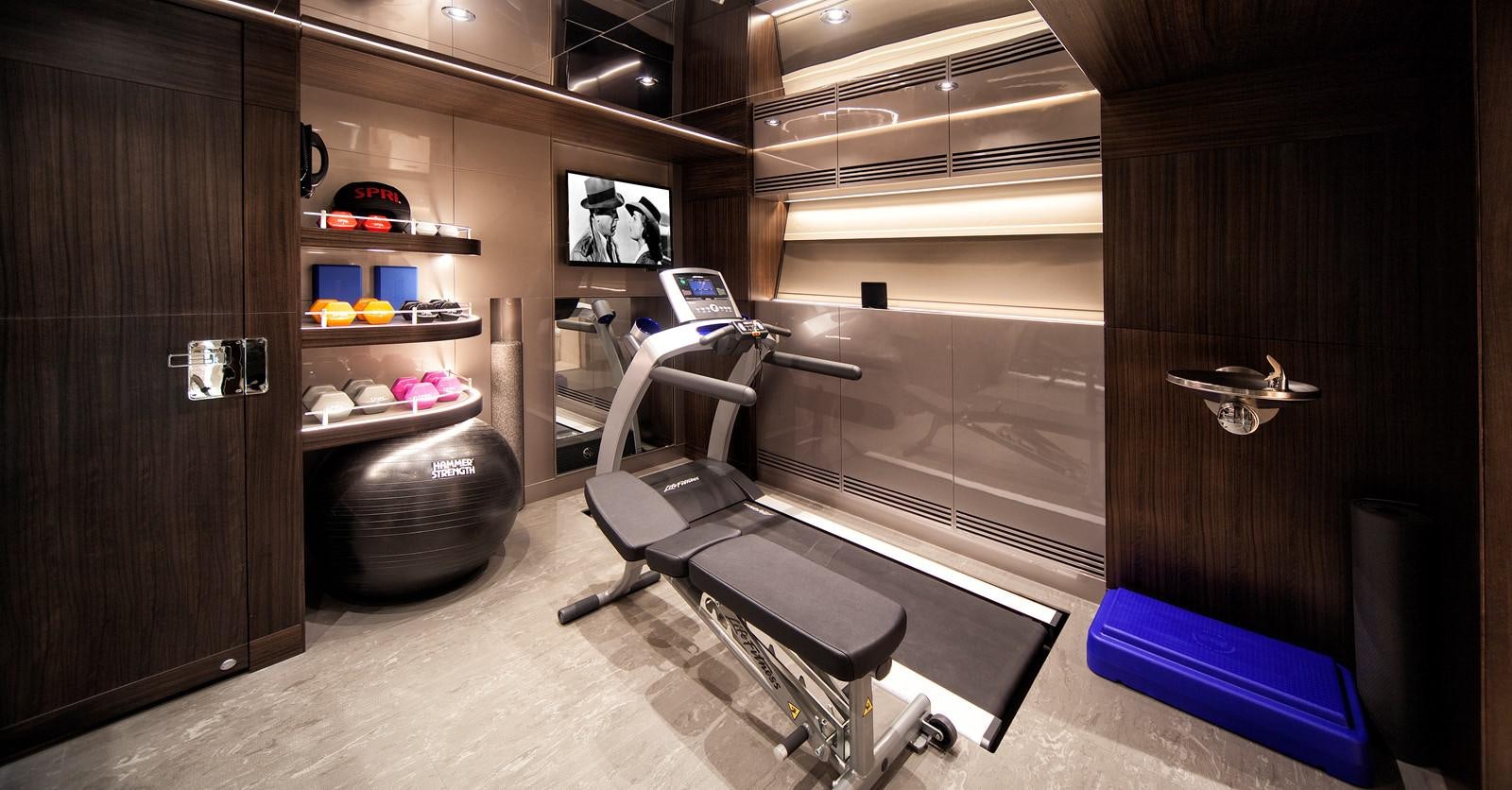 a gym with exercise equipment aboard PEPPER XIII Yacht for Sale