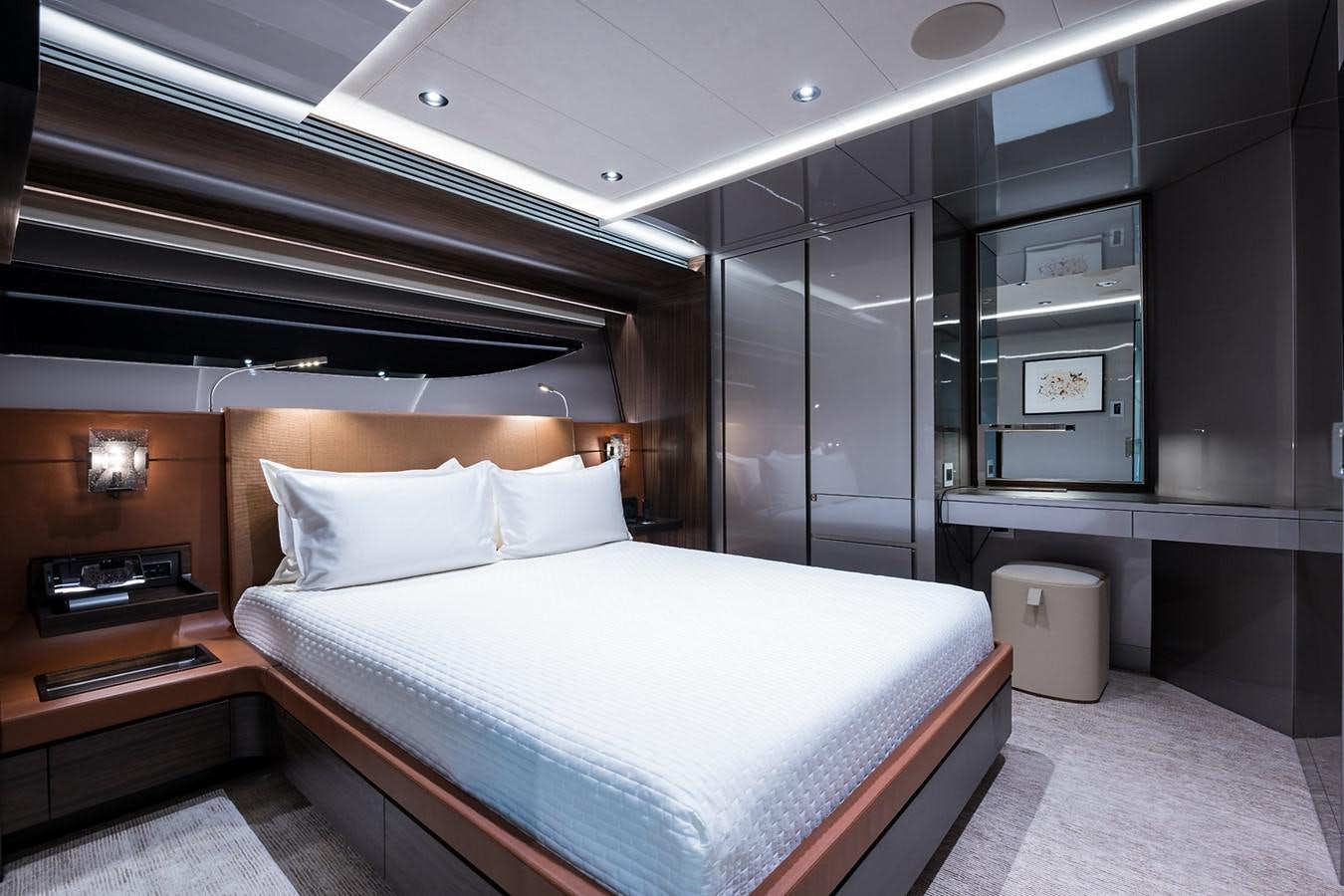 a room with a bed and a desk aboard PEPPER XIII Yacht for Sale