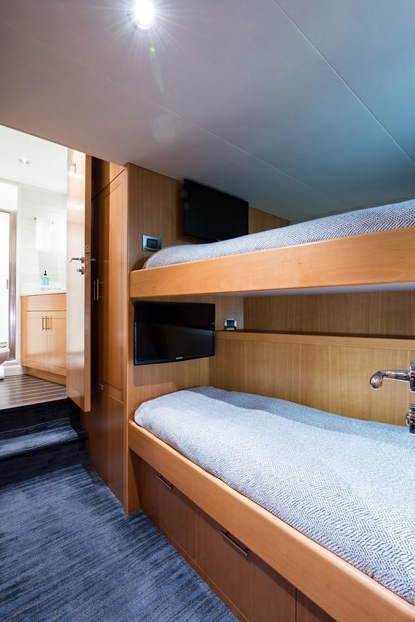 a bed with a wood frame aboard PEPPER XIII Yacht for Sale