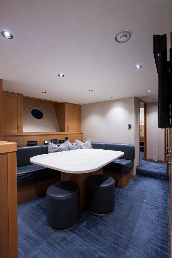 a room with a table and chairs aboard PEPPER XIII Yacht for Sale