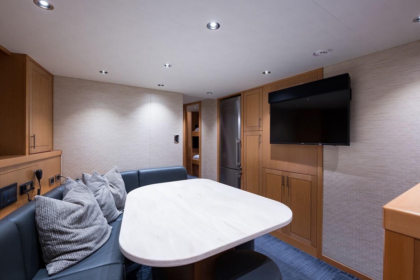 a room with a table and tv aboard PEPPER XIII Yacht for Sale