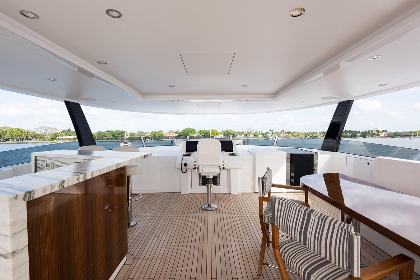 a boat with a deck and chairs aboard PEPPER XIII Yacht for Sale