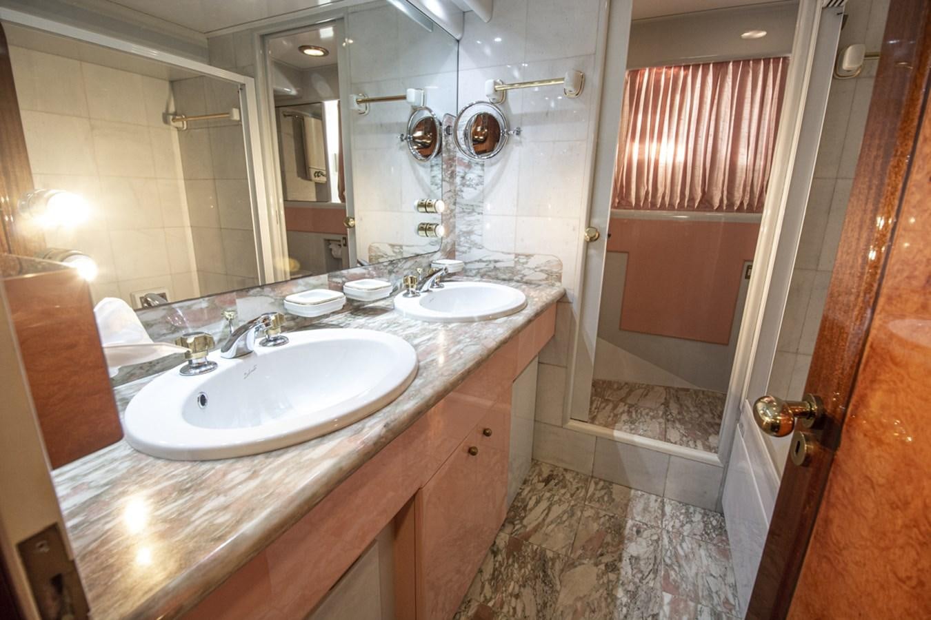 a bathroom with a countertop sink and a mirror aboard ELECTA Yacht for Sale