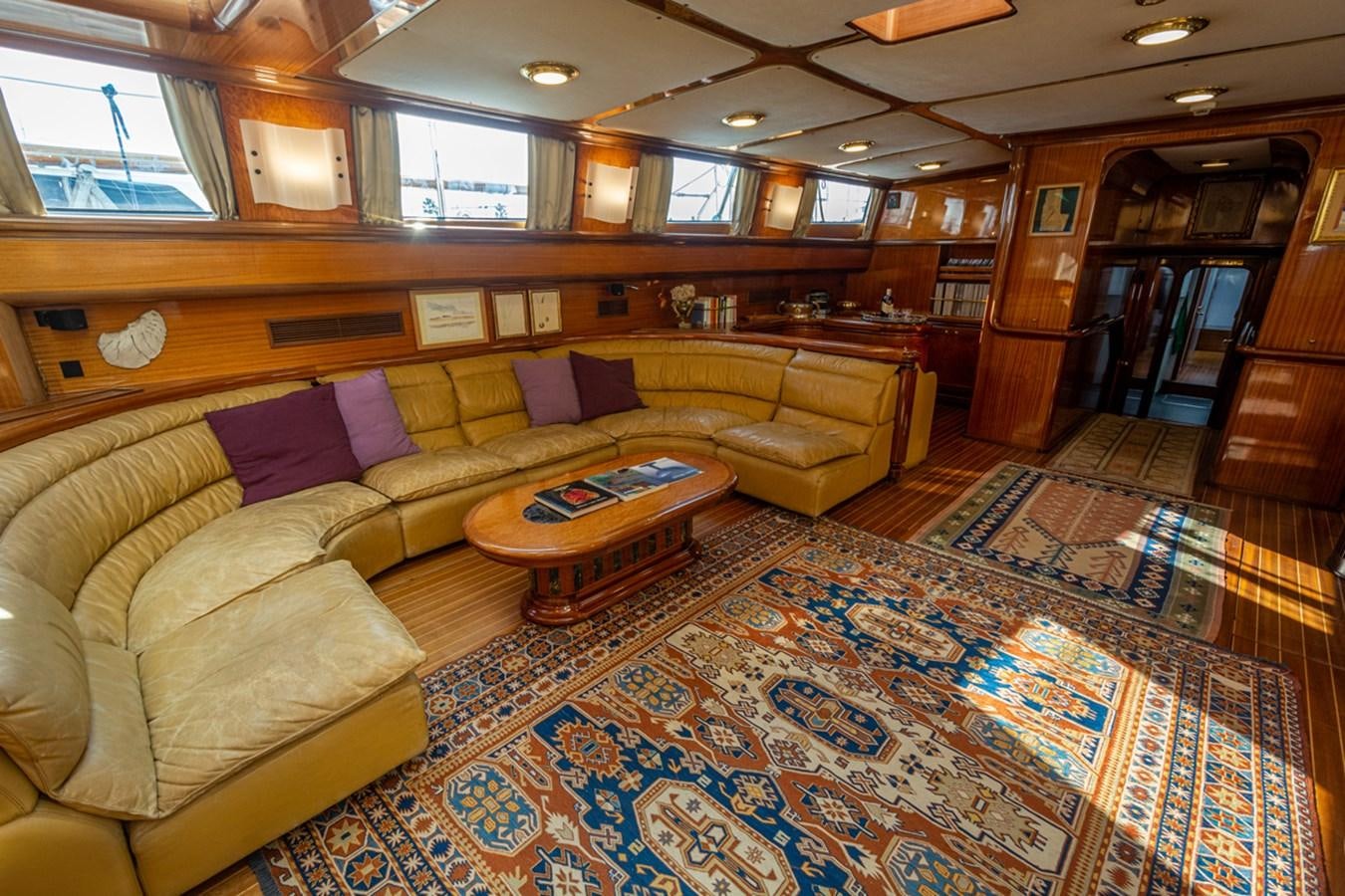 a living room with a couch and a coffee table aboard ELECTA Yacht for Sale