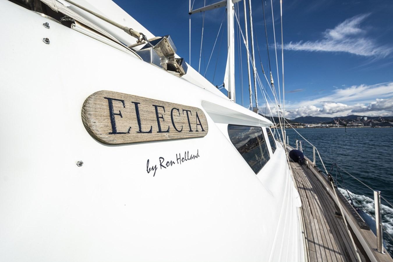 a white boat with a sign on it aboard ELECTA Yacht for Sale