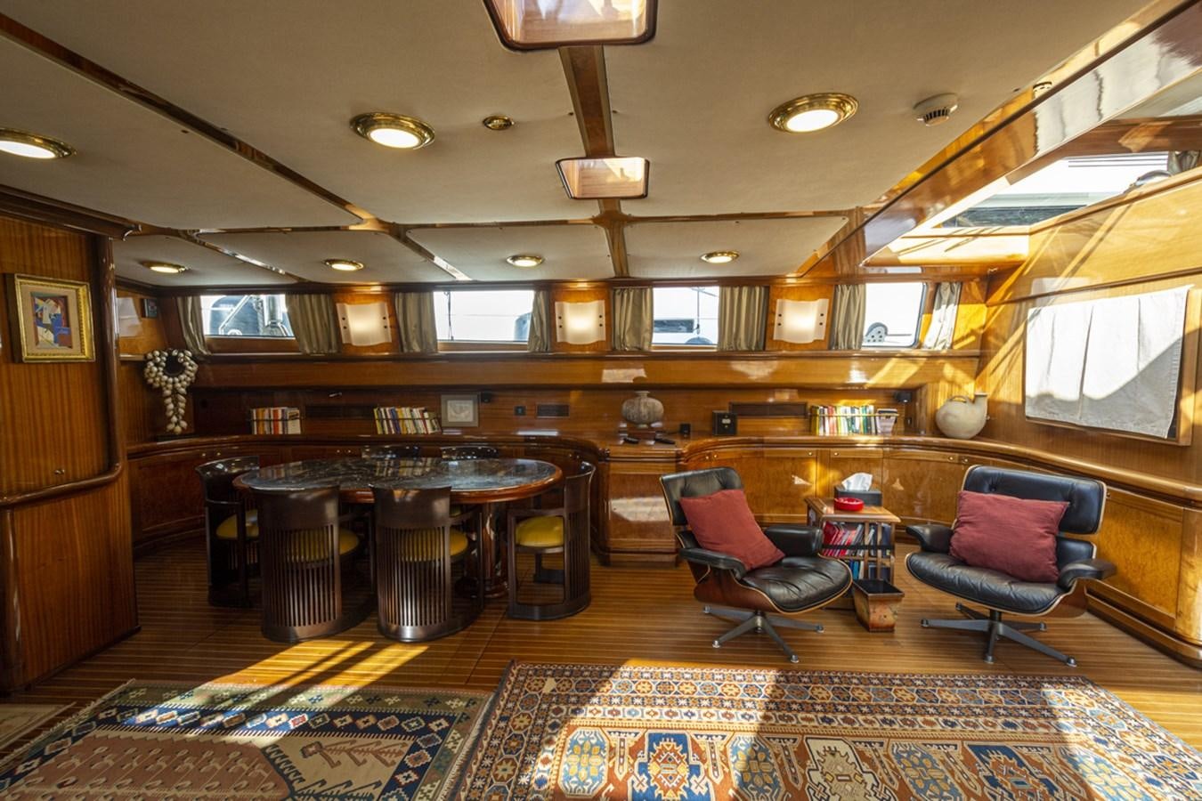 a room with a table chairs and a window aboard ELECTA Yacht for Sale