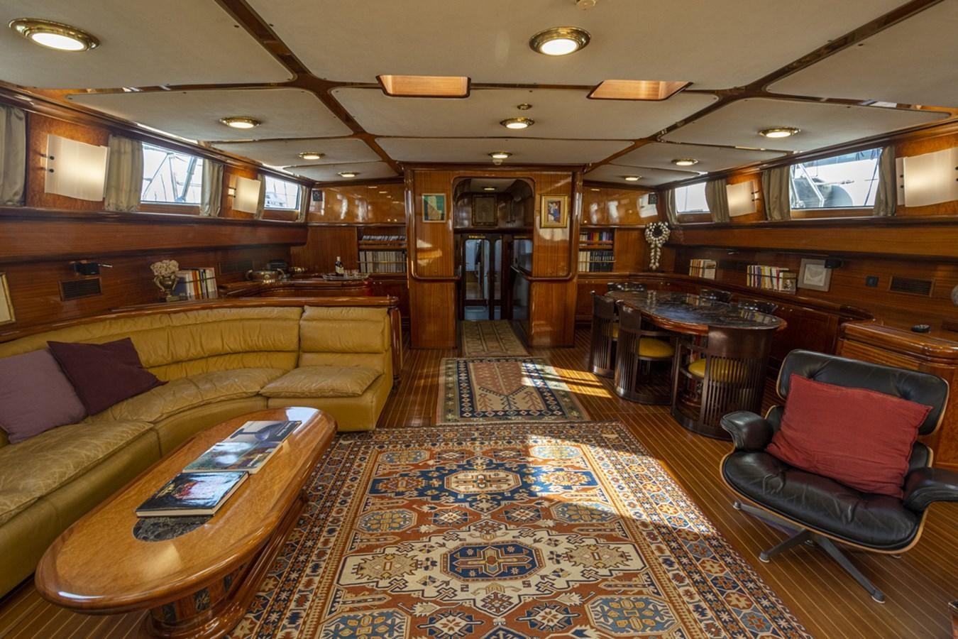 a large room with couches and a table aboard ELECTA Yacht for Sale