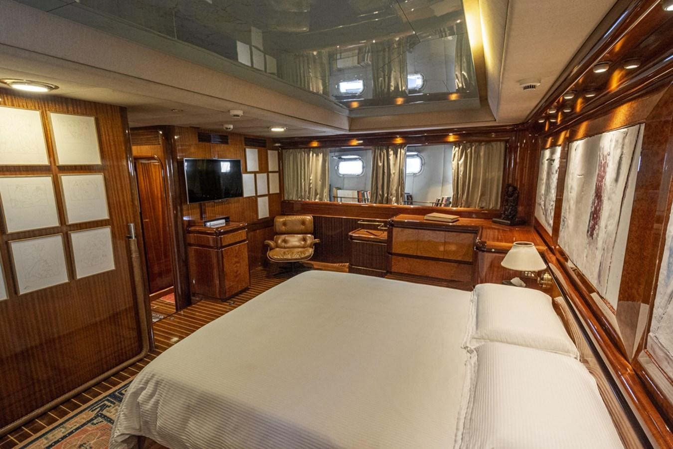 a large room with a bed and a tv aboard ELECTA Yacht for Sale