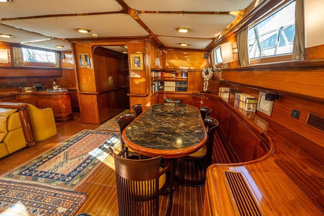 a room with a table and chairs aboard ELECTA Yacht for Sale