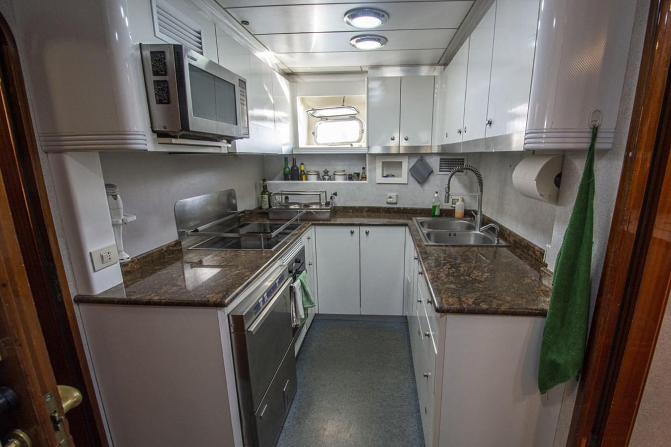 a kitchen with white cabinets aboard ELECTA Yacht for Sale