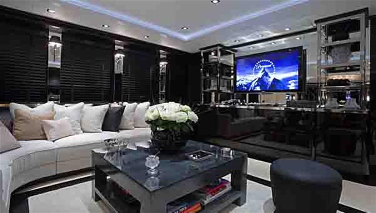 a living room with a large television aboard G-FORCE Yacht for Sale