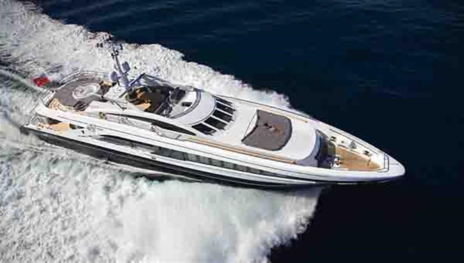 a white boat with a white stripe on the water aboard G-FORCE Yacht for Sale