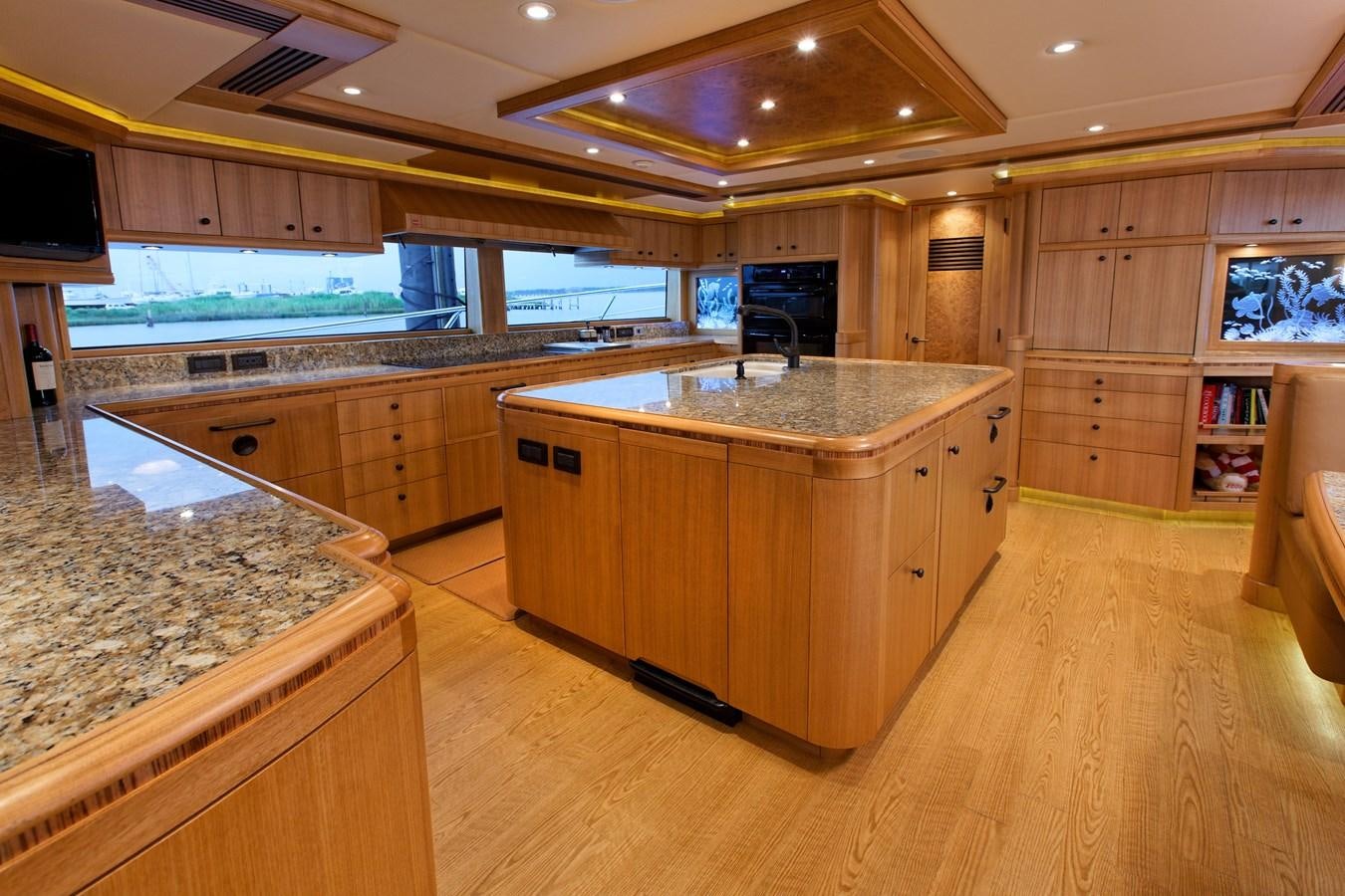 a large kitchen with wooden cabinets aboard ATLANTIS Yacht for Sale