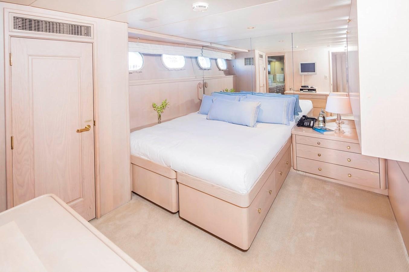 a bedroom with a bed and a desk aboard SILENT WORLD II Yacht for Sale